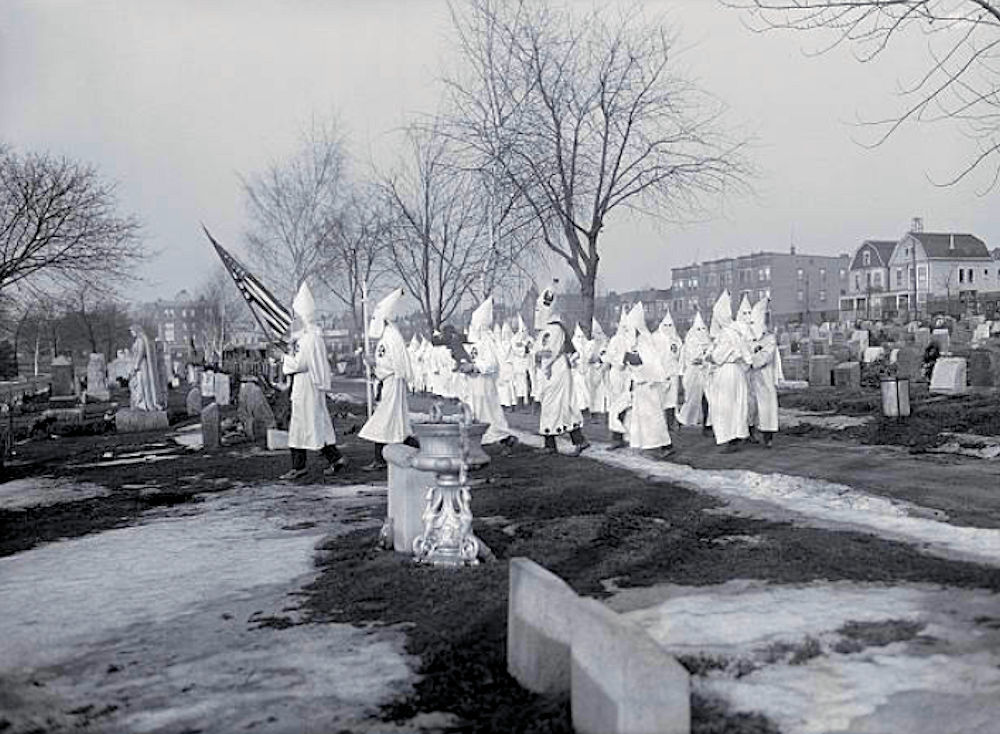 Funeral Service
New Jersey Klansmen Conduct Funeral for Member of Invisible Empire. This remarkable photograph was taken Saturday, March 3rd, 1923 at the Fairmont Cemetery at Newark, N.J. when twenty five Klansmen wearing full regalia, performed burial services over the body of a dead member. No effort was made to stop the demonstration which took but ten minutes. Several hours later, other New Jersey Klansmen at Point Pleasant, planted a wooden cross in a street, set it afire, and then sped away. Hundreds were attracted to the scene of the flaming cross.

Photo from Bettmann
